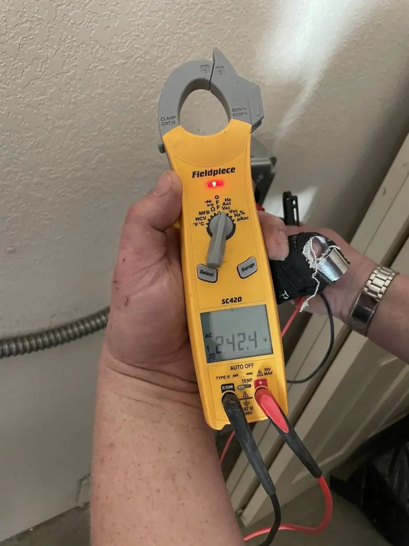 Voltage testing with clamp meter during Recessed Lighting Installation in Haledon